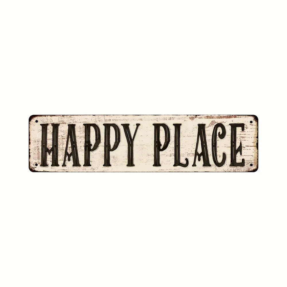 A weathered wooden sign with the text HAPPY PLACE carved into it.