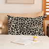 A decorative pillow cover featuring a black and white leopard print on a beige background.
