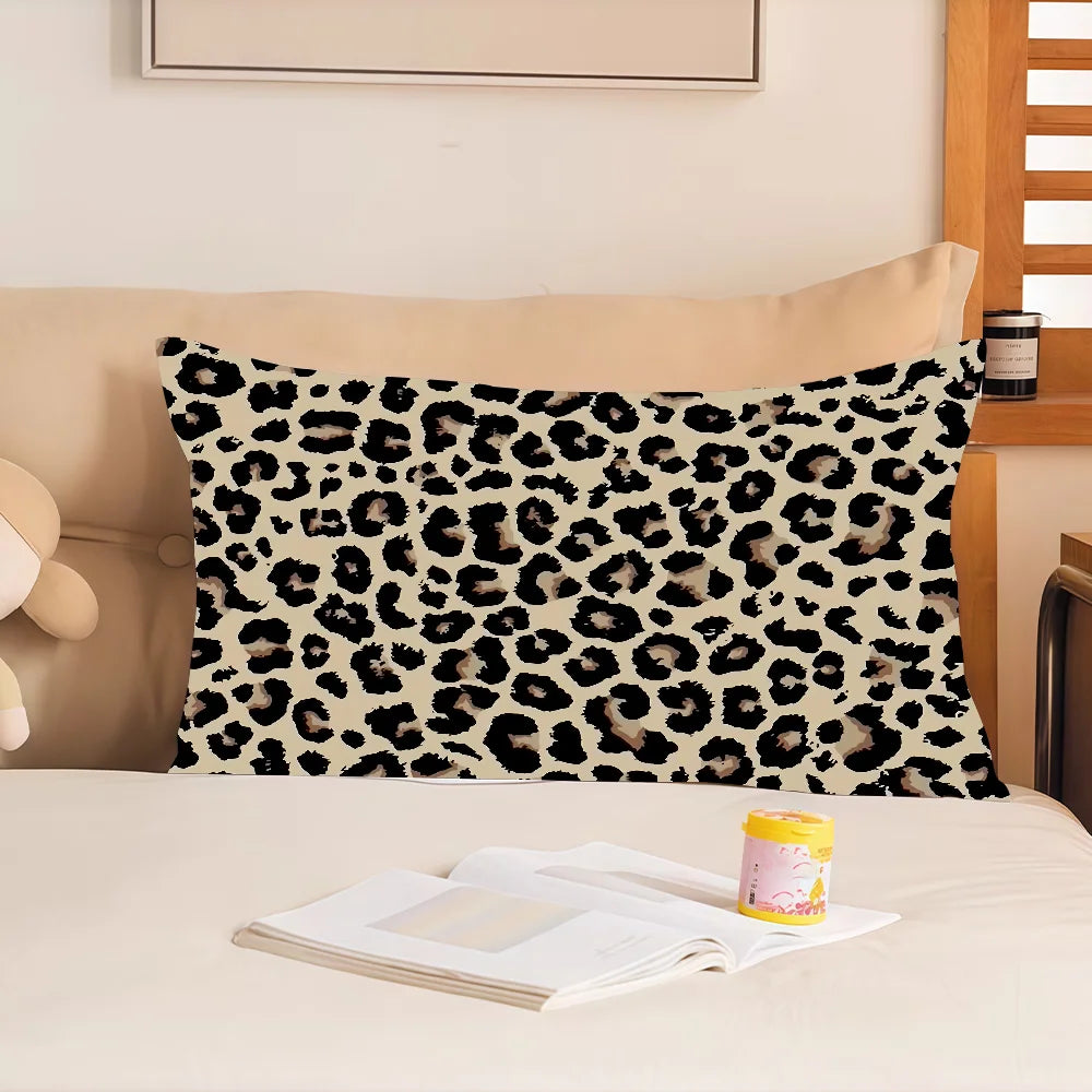 A decorative pillow cover featuring a black and white leopard print on a beige background.