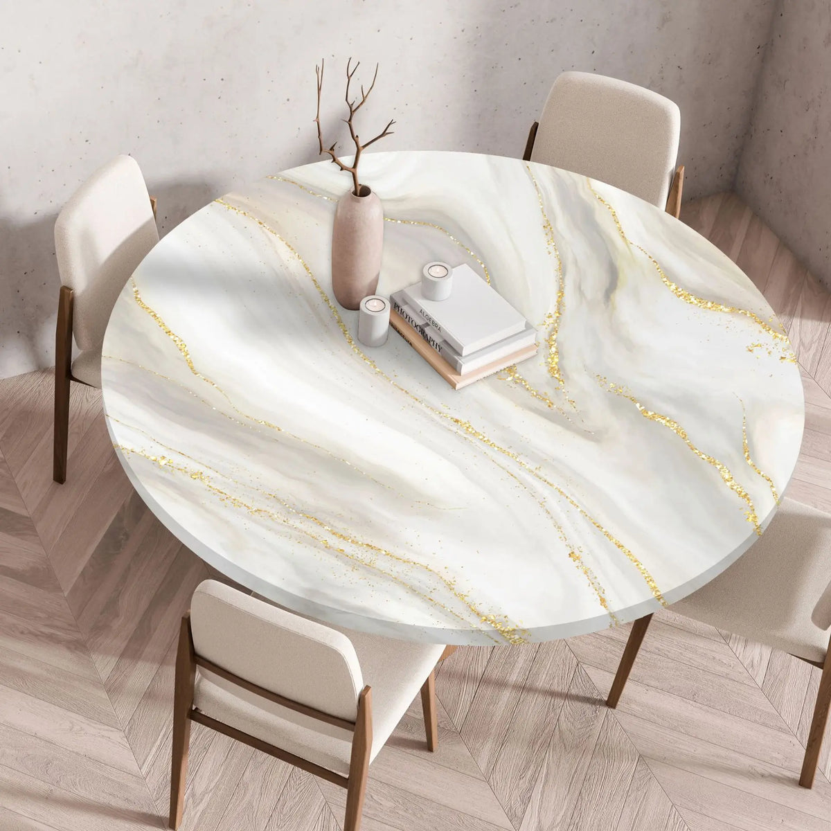 A round marble print tablecloth with gold veins is set on a wooden table surrounded by modern chairs.