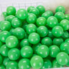A pile of bright green, glossy, spherical ocean balls for kids' play areas.