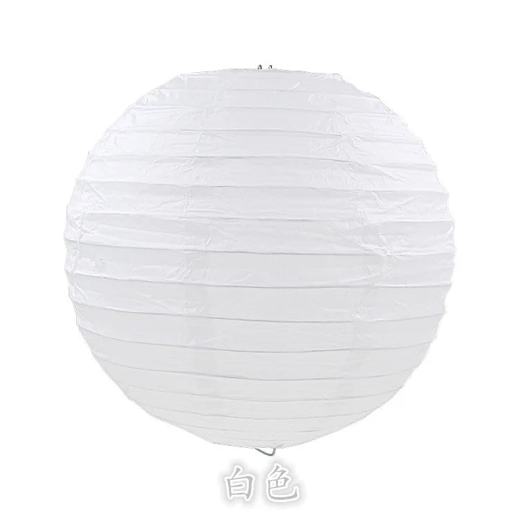 A white round paper lantern used for parties and weddings.