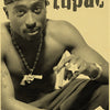 A black and white portrait of Tupac featuring a cap, necklace with a pendant, and tattoos.
