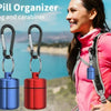 A woman wearing a pink jacket is shown next to a metal pill organizer keychain in black, blue, and red colors.