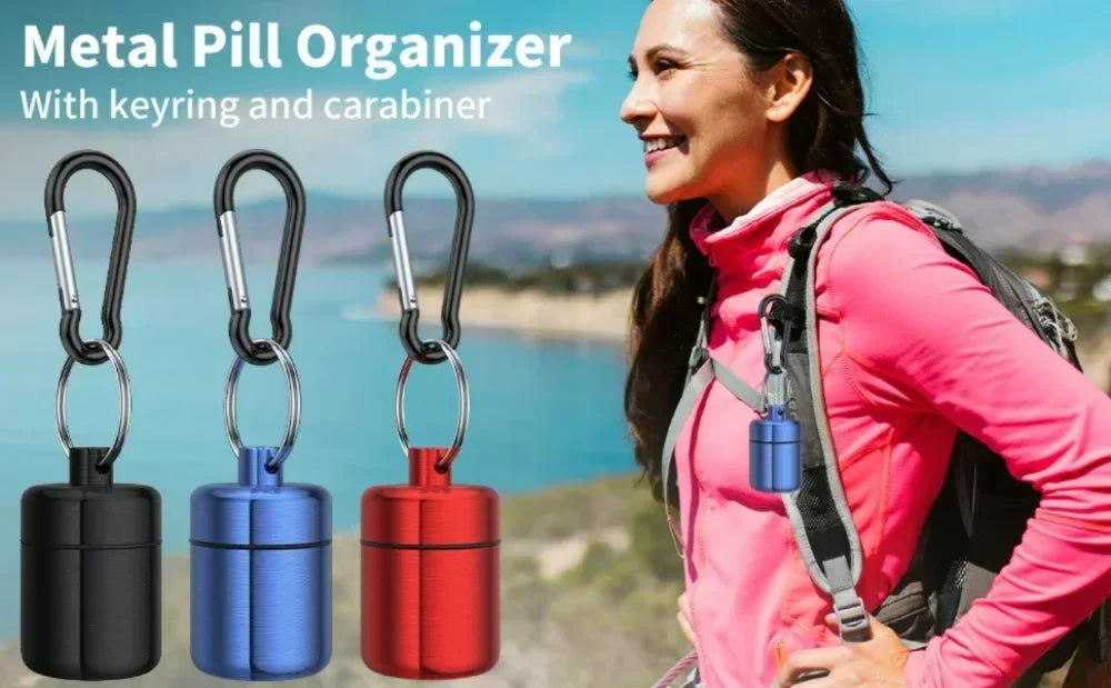 A woman wearing a pink jacket is shown next to a metal pill organizer keychain in black, blue, and red colors.