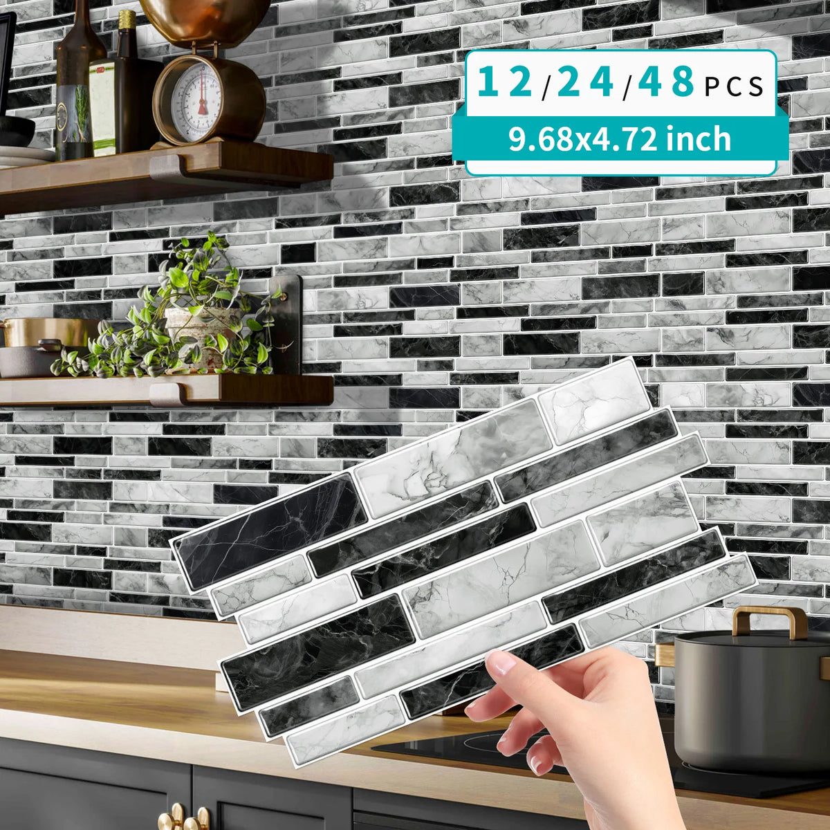 Self-adhesive marble wall tiles in various shades of gray and white being held by a hand against a dark subway tile backgroun