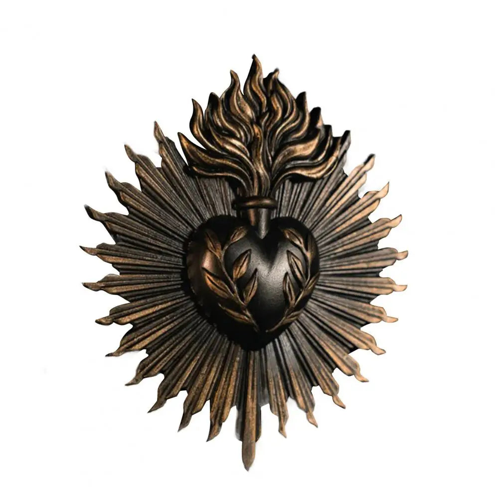 A dark bronze wall plaque featuring a stylized sacred heart design with radiating lines.