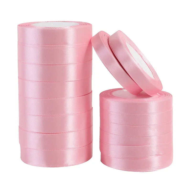 Rolls of pink silk satin ribbons for crafting