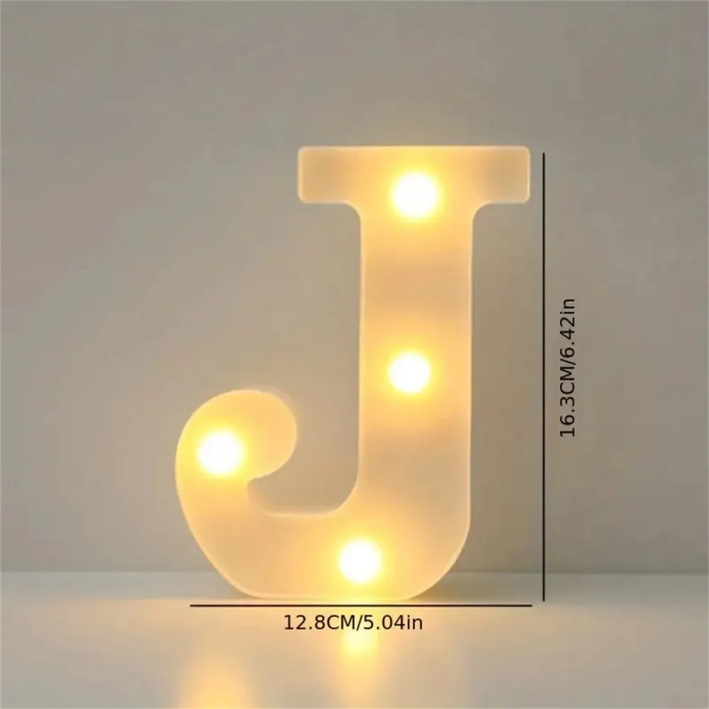 A glowing letter J made of LED lights on a white surface.