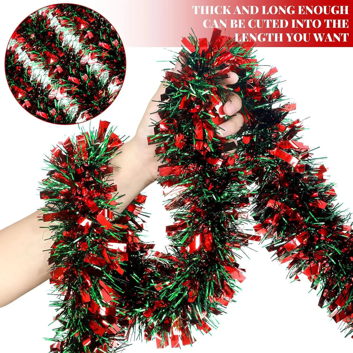 A hand is holding a thick, long red and green festive Christmas tinsel garland for holiday decor.