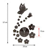 Modern acrylic wall clock featuring a butterfly and floral design on a black background.