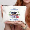 A cream-colored canvas makeup bag with blue text that reads Happy Teacher's Day and Ms. Taylor
