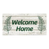 Rustic wooden hanging sign with green lettering that reads Welcome Home and features laurel leaves on a weathered wood backgr
