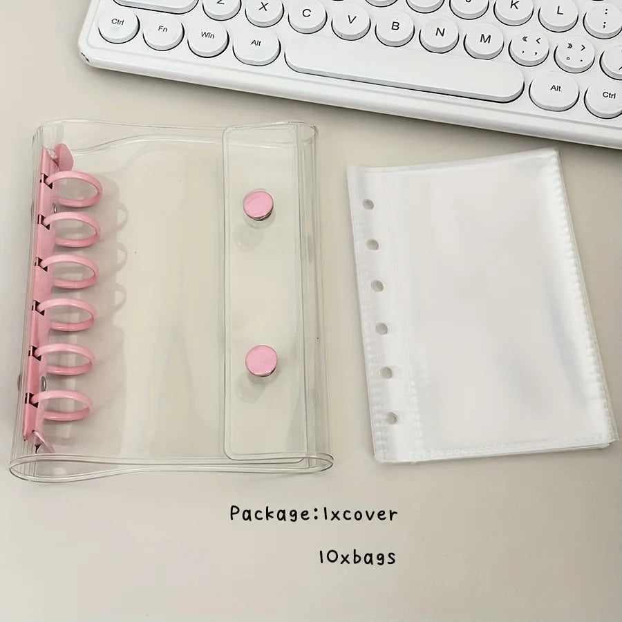 A clear plastic binder cover and a white folder are shown next to a white keyboard.