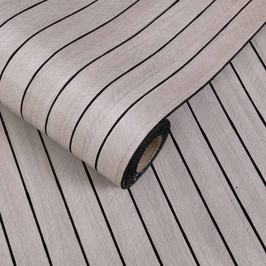 Roll of self-adhesive 3D wood grain wall panels showing parallel dark lines on a light background.
