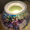 A glass jar filled with colorful wax and a clear lid, showing the E12 candelabra base for a candle.