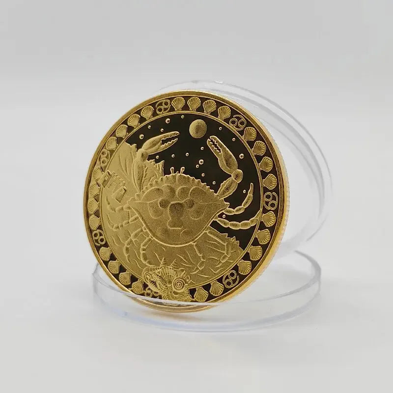 A round gold commemorative iron coin featuring a detailed crab design surrounded by decorative borders.