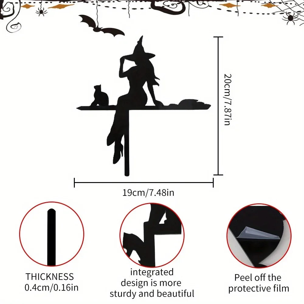 Black metal prayer cross wall art featuring a silhouette of a figure and a small animal on a shelf