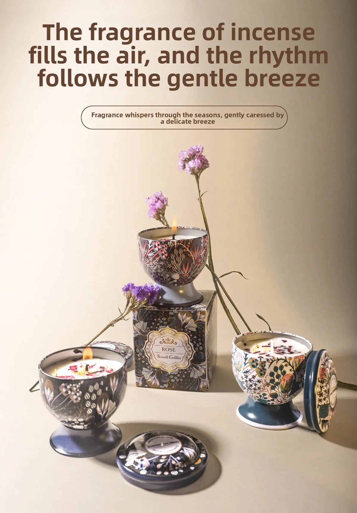 A set of decorative candles in ornate tins and glass holders with floral designs on a light surface.