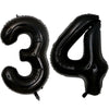 A set of two black foil balloons shaped like the number 3 and 4.