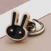 A gold-toned and black rabbit no-sew brooch button with a shiny finish.