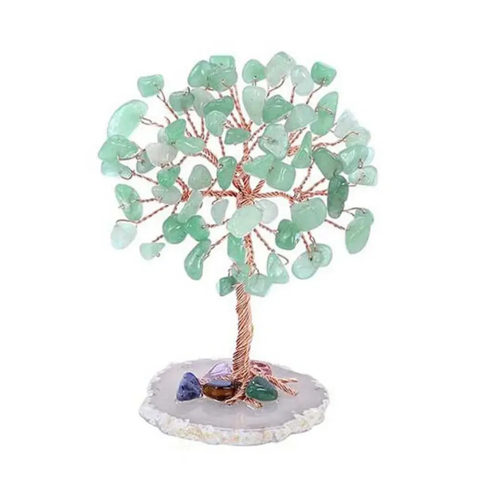 A small crystal money tree decor featuring green and clear translucent stones on a wooden branch.