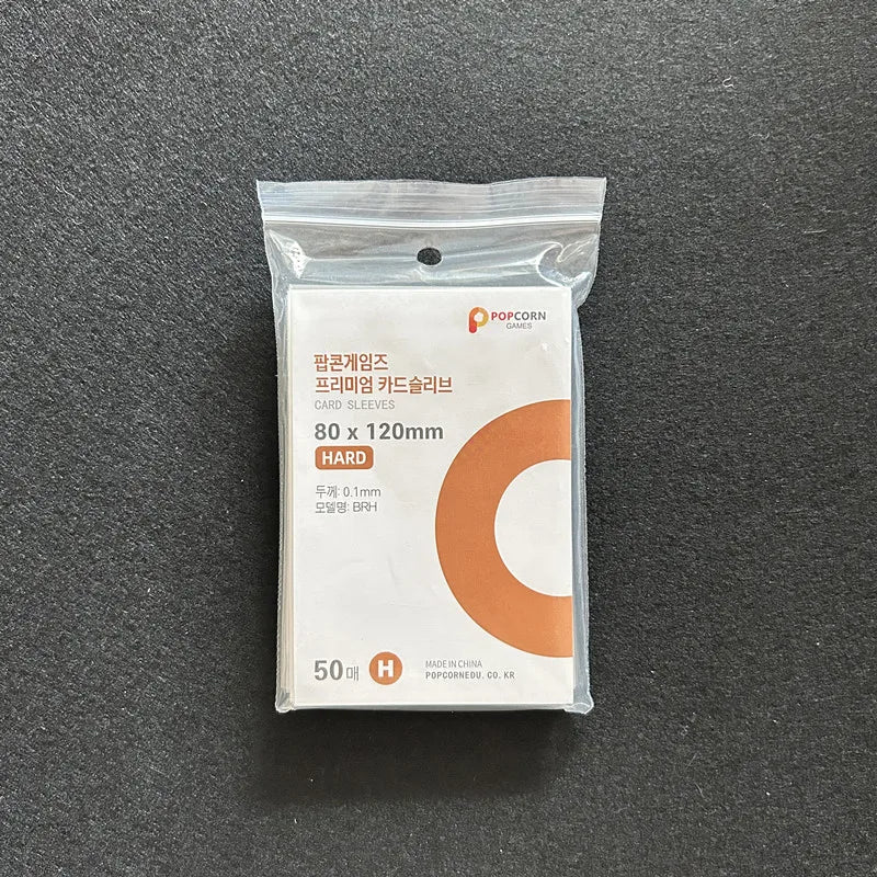 A clear plastic package containing 50 hard card sleeves for popcorn games.