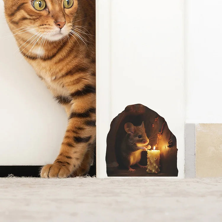 A close-up of a tabby cat looking at a small mouse figurine with a candle in a decorative niche.