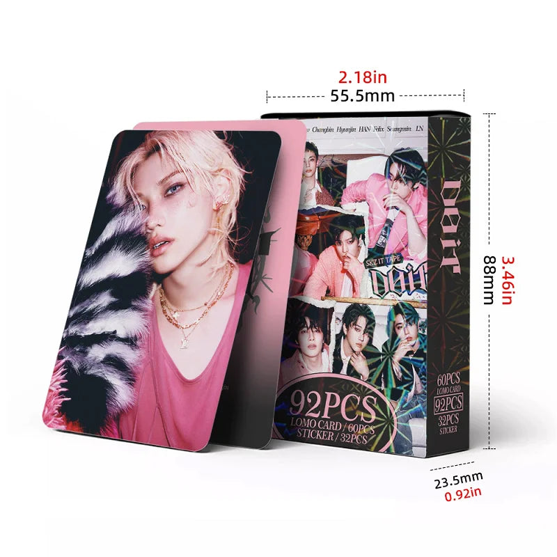A vertical box containing a photo card set for Stray Kids featuring member images and bonus stickers.