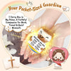 A handcrafted crochet animal doll is held in a person's palm, accompanied by a message card.