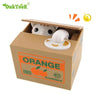 An orange cardboard box containing an interactive coin bank shaped like a white animal for kids.