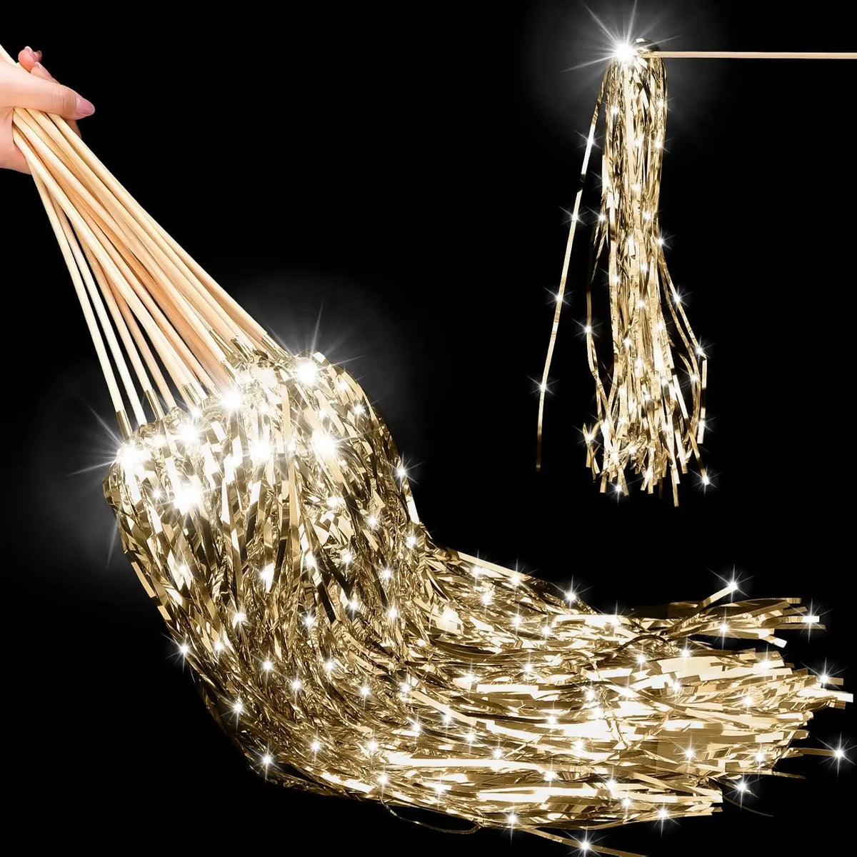 A close-up of golden lighted tinsel wedding wands with LED glow hanging from a string.