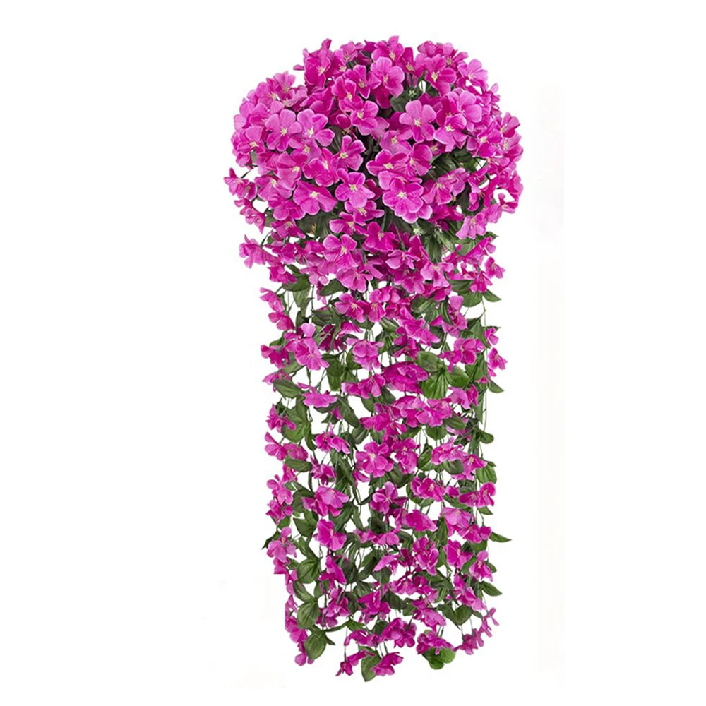 A dense hanging garland of vibrant pink and magenta artificial violet ivy flowers.