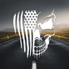 A white skull decal featuring the American flag design is placed on a dark asphalt road.