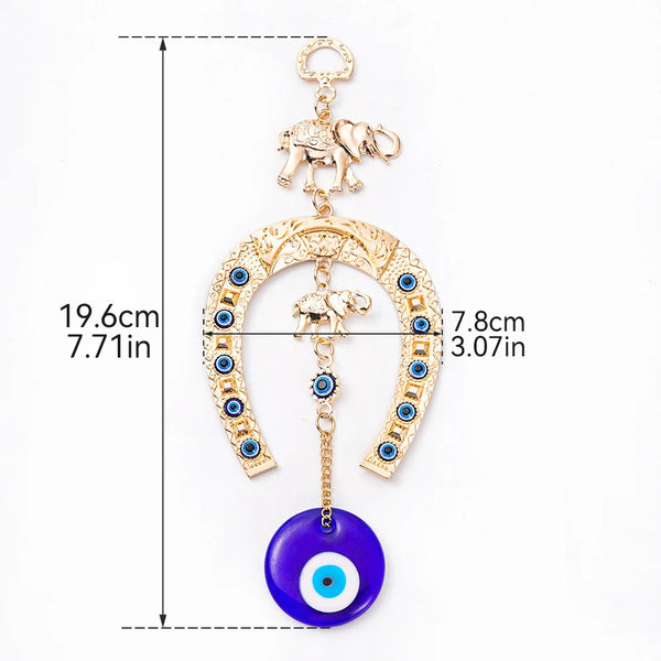 Gold amulet featuring an elephant charm and a blue eye pendant on a horseshoe shape.