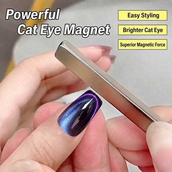A hand holds a silver rectangle cat eye magnet with a purple iridescent gel polish on a fingernail.