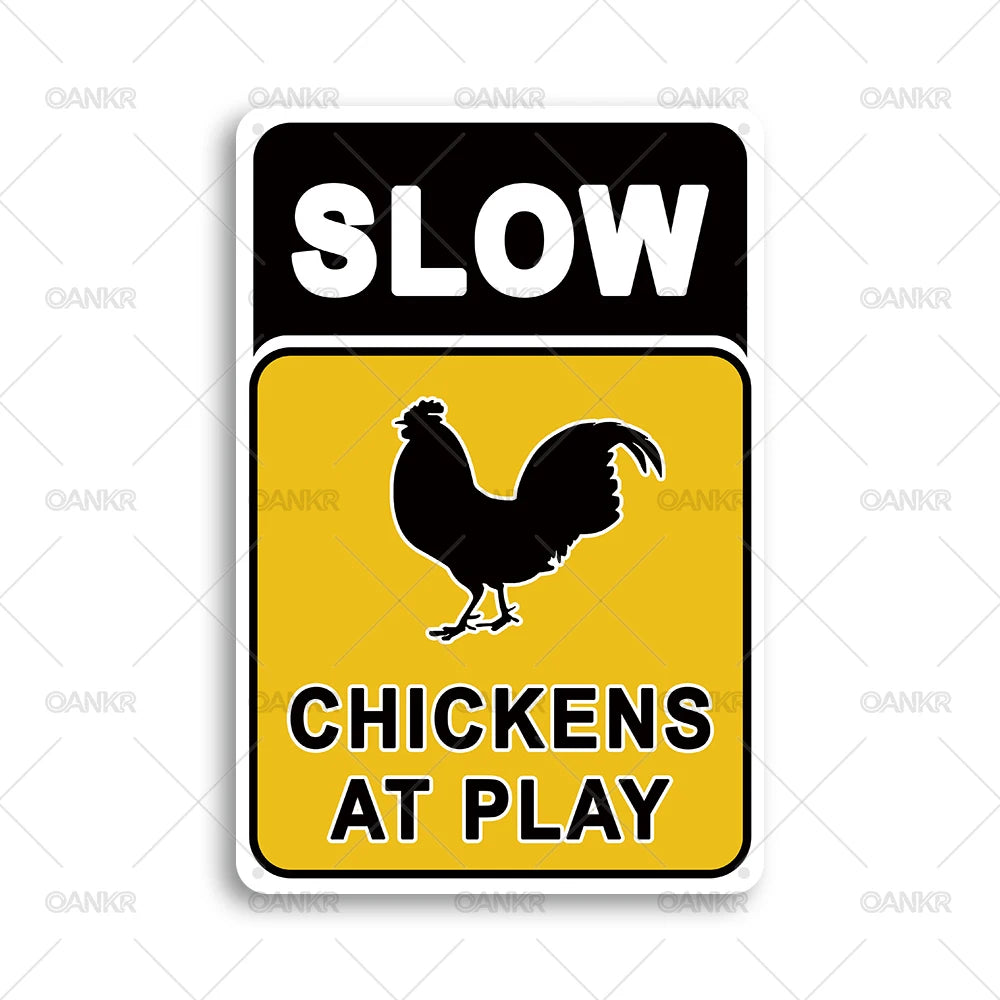 A black and yellow warning sign with the text SLOW CHICKENS AT PLAY.