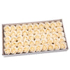 A tray filled with numerous cream-colored artificial rose heads for wedding and party decoration.