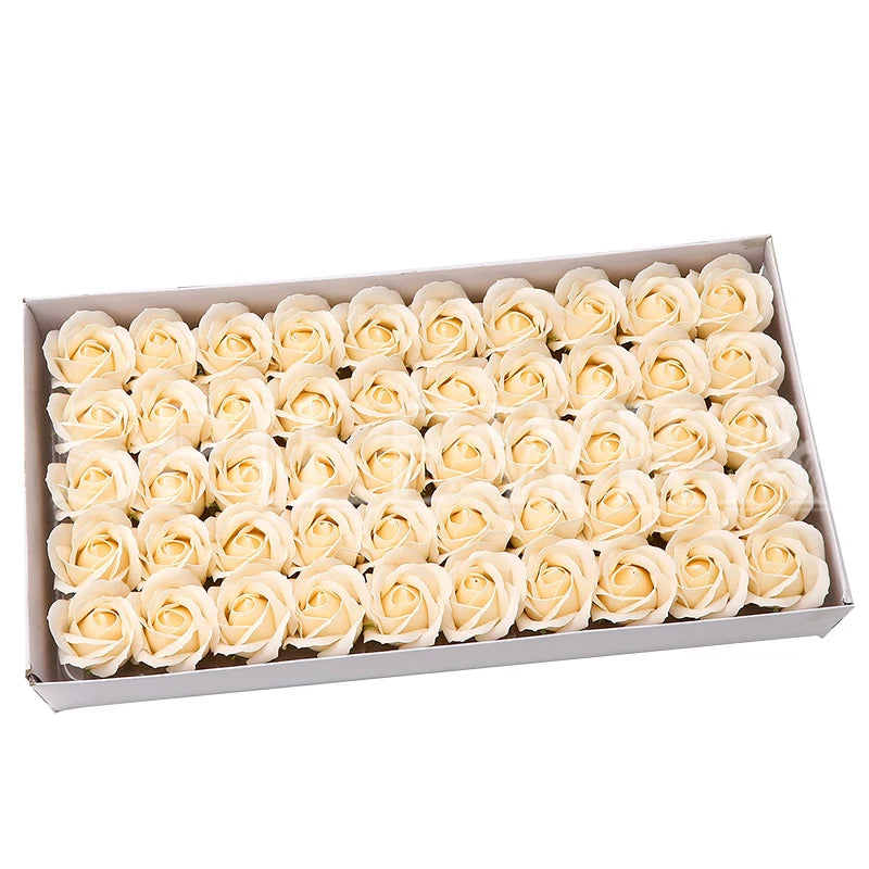 A tray filled with numerous cream-colored artificial rose heads for wedding and party decoration.