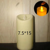 A tall, cylindrical white candle with the dimensions 7.5 by 15, set against a light wooden background.