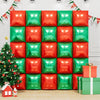 A grid of red and green square foil balloon wall panels with a Christmas tree and a gift box.
