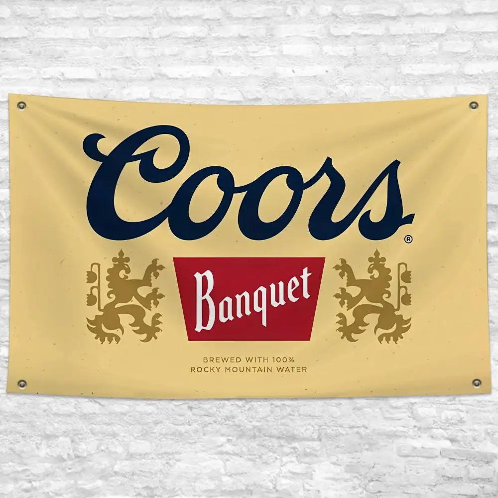 A beige banner featuring the Coors Banquet beer logo in dark blue and red, with text indicating it is brewed with Rocky Mount
