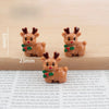 A set of festive Christmas resin decor featuring two small deer figurines in brown and green colors.