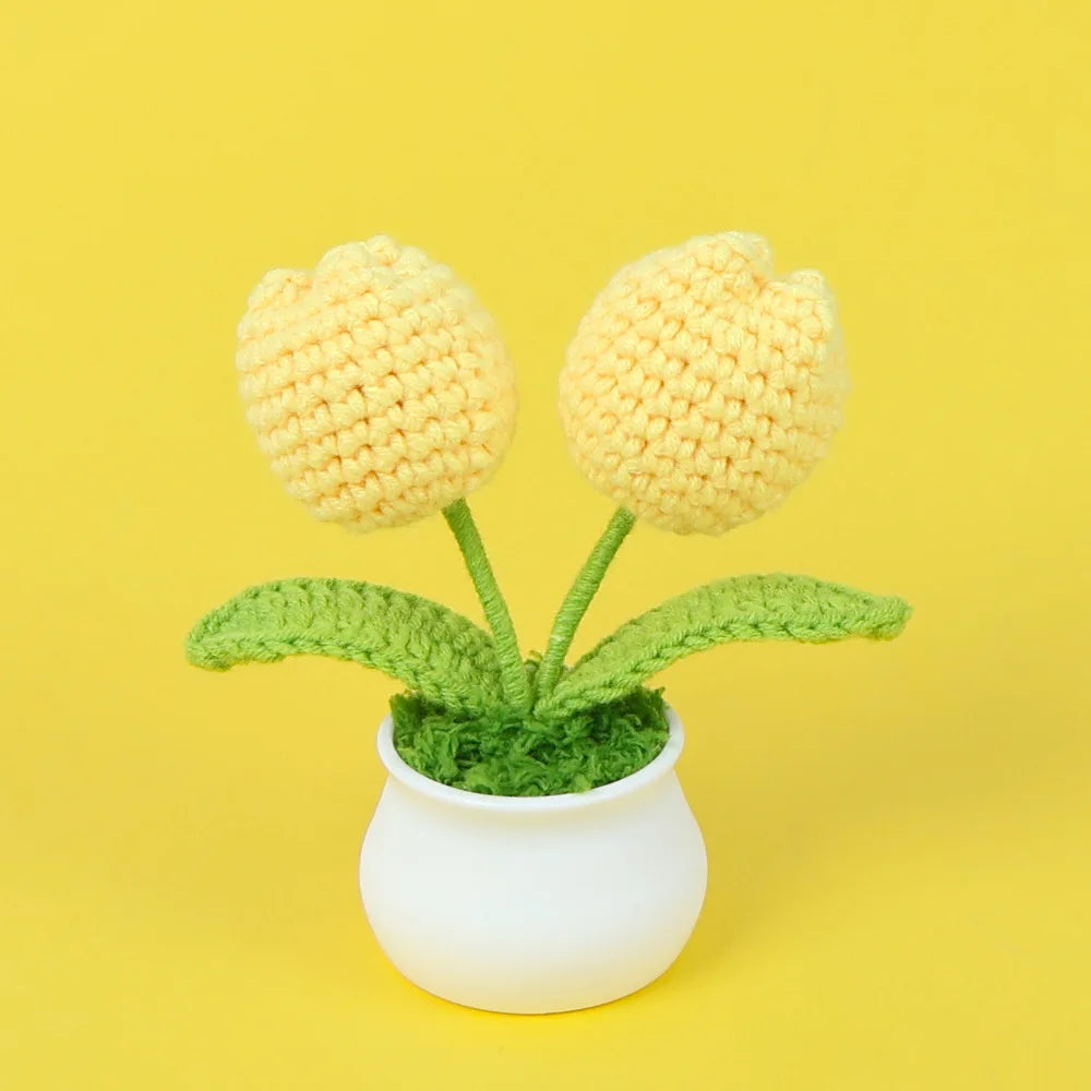Hand woven crochet yellow flowers in a white pot on a yellow background