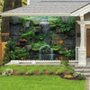 A decorative wall hanging featuring a waterfall and lush green plant tapestry in a garden setting.
