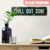 A vintage metal sign with the text CHILL OUT ZONE is displayed on a shelf next to a dark vase and a glass.