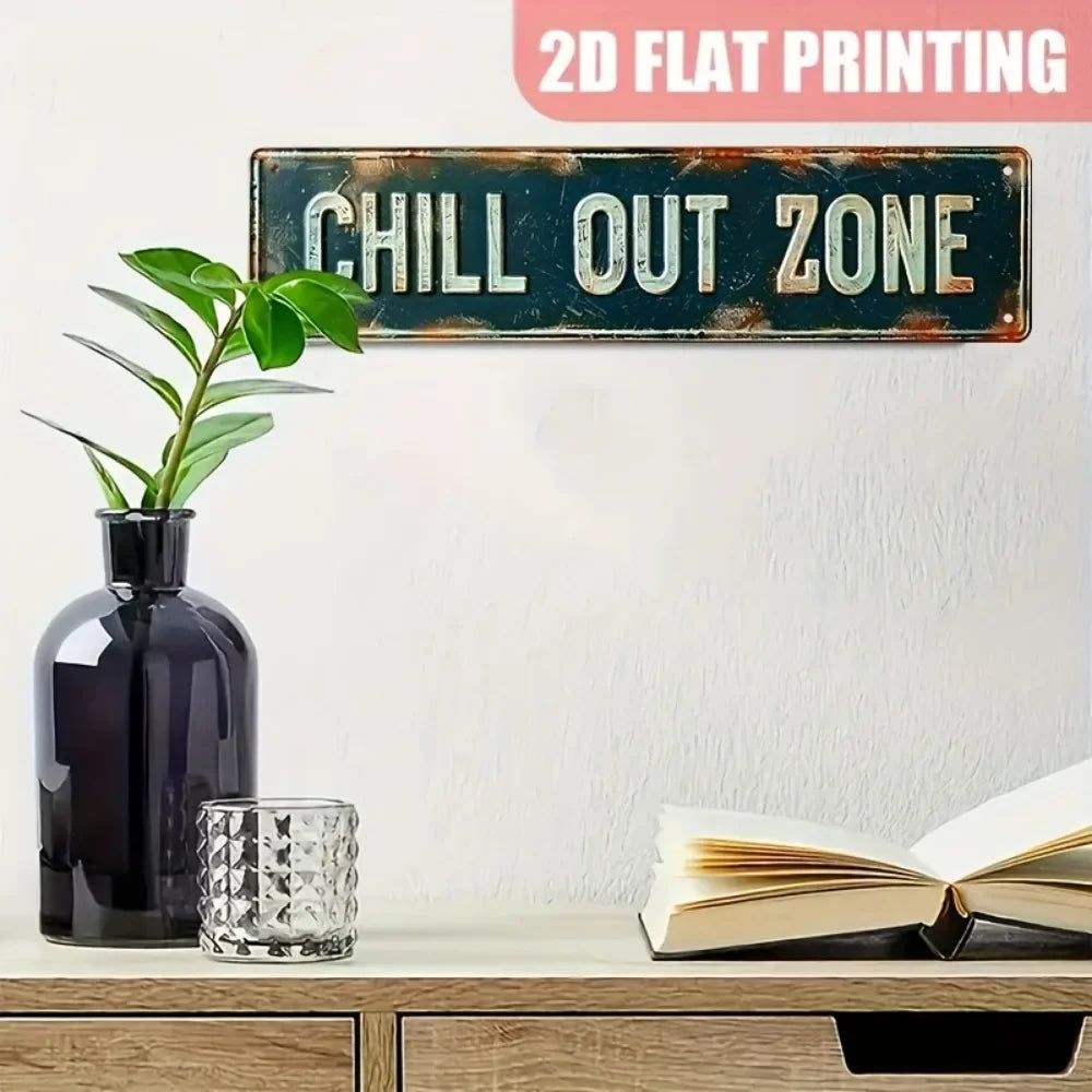 A vintage metal sign with the text CHILL OUT ZONE is displayed on a shelf next to a dark vase and a glass.