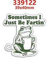 A green frog charm with text that reads Sometimes I Just Be Fartin'