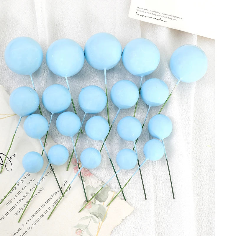 A set of twenty light blue spherical cake toppers on thin sticks displayed against a white background.