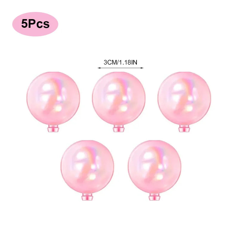 A set of five pink mermaid tail cake toppers featuring seashell and sea star decorations.